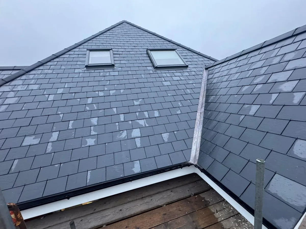 New roof with natural Spanish slates, Velux windows, lead valley and dry ridge system.